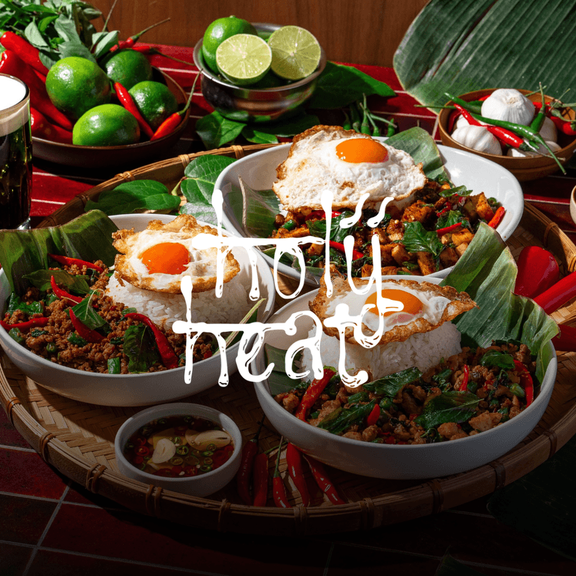 White Holy Heat logo overlaid Pad Kra Pow bowls with spicy Thai basil stir-fry, white rice, and crispy fried eggs, surrounded by fresh chilies, limes, garlic, and Thai-inspired ingredients.